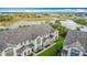 An aerial view of townhouses beside a highway, showcasing the proximity to a peaceful lake at 426 Captiva Dr, Davenport, FL 33896