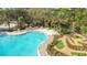 A relaxing community pool, lounge chairs, and mini-golf area surrounded by mature landscaping at 426 Captiva Dr, Davenport, FL 33896