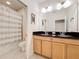 Bathroom featuring double sinks, tile flooring, and shower and tub combo at 426 Captiva Dr, Davenport, FL 33896