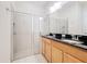 Bathroom featuring double sinks, tile flooring, and glass-enclosed shower at 426 Captiva Dr, Davenport, FL 33896