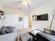 Bright bedroom featuring a sleeper sofa, desk, TV, and ceiling fan at 426 Captiva Dr, Davenport, FL 33896