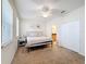 Bedroom features a queen size bed, ceiling fan, and lots of natural light at 426 Captiva Dr, Davenport, FL 33896