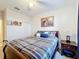 Bedroom featuring a queen bed, side tables, ceiling fan and closet at 426 Captiva Dr, Davenport, FL 33896