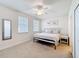 Bright bedroom featuring a ceiling fan, queen sized bed, and two windows at 426 Captiva Dr, Davenport, FL 33896