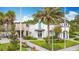 Beautiful clubhouse exterior with lush landscaping, palm trees, and sidewalk at 426 Captiva Dr, Davenport, FL 33896