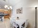 Cozy dining area adjacent to the kitchen, featuring a white table and decorative chandelier at 426 Captiva Dr, Davenport, FL 33896