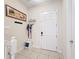 Organized entryway with tiled floor, coat hooks, and a shoe storage, for added convenience at 426 Captiva Dr, Davenport, FL 33896