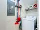 This laundry room is equipped with a washer, shelving, and cleaning supplies at 426 Captiva Dr, Davenport, FL 33896