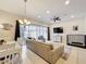 Bright living room with a patio view, featuring a comfortable sofa and a stylish chandelier at 426 Captiva Dr, Davenport, FL 33896
