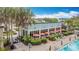 Poolside dining and lounge area with orange umbrellas at 426 Captiva Dr, Davenport, FL 33896