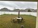 Backyard featuring a white fence, lawn, patio table with chairs, and neighboring houses at 4406 Hidden Meadow Dr, Kissimmee, FL 34746