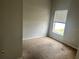 A simple bedroom with minimal fixtures and a window offering natural light at 4406 Hidden Meadow Dr, Kissimmee, FL 34746
