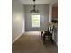 Carpeted dining area with a window and lighting fixture at 4406 Hidden Meadow Dr, Kissimmee, FL 34746
