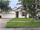 Charming single-Gathering home with a well-maintained lawn and a two-car garage at 4406 Hidden Meadow Dr, Kissimmee, FL 34746