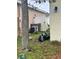 Exterior side yard view showing AC unit, black trash bag and fence at 4406 Hidden Meadow Dr, Kissimmee, FL 34746