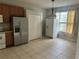 Eat in kitchen area with tile flooring, brown cabinets, and natural light at 4406 Hidden Meadow Dr, Kissimmee, FL 34746