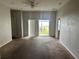 Spacious living room with carpet flooring and access to the backyard at 4406 Hidden Meadow Dr, Kissimmee, FL 34746