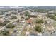 Aerial view of a neighborhood showcasing single-Gathering homes surrounded by lush greenery and roadways at 4491 Sw 151 St, Ocala, FL 34473