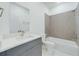 This bathroom features grey cabinets, quartz countertops, a toilet, and a tub at 4491 Sw 151 St, Ocala, FL 34473
