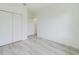 Bright bedroom showcasing natural light, neutral walls, wood floors, and double door closet at 4491 Sw 151 St, Ocala, FL 34473