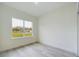 An empty bedroom featuring a large window offering neighborhood views at 4491 Sw 151 St, Ocala, FL 34473