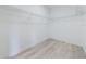 This empty closet features metal racks and wooden floors at 4491 Sw 151 St, Ocala, FL 34473