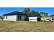Lovely single-story home with neutral stucco, a dark roof, a dark two-car garage, and well-manicured yard at 4491 Sw 151 St, Ocala, FL 34473