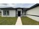 Charming front exterior of a single-story home with neutral stucco and a well-maintained lawn at 4491 Sw 151 St, Ocala, FL 34473
