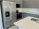 Close-up of the kitchen featuring a stainless steel refrigerator and sleek countertops at 4491 Sw 151 St, Ocala, FL 34473