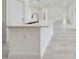 Bright kitchen features a white quartz countertop island with brass fixtures and stainless steel sink at 4491 Sw 151 St, Ocala, FL 34473