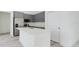 Modern kitchen with gray cabinets, stainless steel appliances, and a white countertop island at 4491 Sw 151 St, Ocala, FL 34473