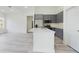 Well-lit open-concept kitchen with gray cabinets, stainless steel appliances, and quartz countertops at 4491 Sw 151 St, Ocala, FL 34473