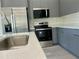 Beautiful kitchen with modern appliances, sleek countertops, and grey cabinetry at 4491 Sw 151 St, Ocala, FL 34473