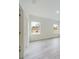 This living room is bright with natural light and features wood floors and two windows at 4491 Sw 151 St, Ocala, FL 34473