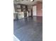 The garage has a refrigerator, shelving, and a gray epoxy coated floor at 4710 Willoughby St, Kissimmee, FL 34758