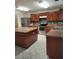 Spacious kitchen featuring an island, stainless steel appliances, and wood cabinets at 4710 Willoughby St, Kissimmee, FL 34758