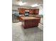 Kitchen featuring a central island, stainless appliances, tile floors and wood cabinets at 4710 Willoughby St, Kissimmee, FL 34758