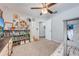 Charming bedroom with a ceiling fan, a bookshelf, and an animal-themed decoration for a playful and inviting atmosphere at 4740 Cypress Forest Ln, St Cloud, FL 34772