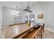 Bright dining room with large wood table, bench seating, gallery wall, and modern light fixtures at 4740 Cypress Forest Ln, St Cloud, FL 34772
