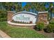 Welcome to Cypress Preserve: a beautifully landscaped community entrance with stone accents and lush greenery at 4740 Cypress Forest Ln, St Cloud, FL 34772