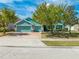 Charming single-story home featuring a three-car garage and inviting curb appeal with mature trees and landscaping at 4740 Cypress Forest Ln, St Cloud, FL 34772