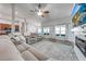 Comfortable living room featuring a plush sofa, hardwood floors, neutral walls, and an entertainment center at 4740 Cypress Forest Ln, St Cloud, FL 34772