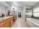 Spacious bathroom offering dual vanities, a soaking tub, a separate shower, and ample closet space at 4740 Cypress Forest Ln, St Cloud, FL 34772