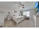 Light and airy main bedroom with a ceiling fan, TV, and a cozy sitting area by the window at 4740 Cypress Forest Ln, St Cloud, FL 34772