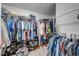 Walk-in closet with extensive hanging rods and shelving for organized storage of clothing and accessories at 4740 Cypress Forest Ln, St Cloud, FL 34772