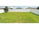 Large, grassy backyard enclosed by a white vinyl fence, perfect for outdoor activities at 486 Disa Dr, Davenport, FL 33837