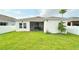 Expansive backyard featuring a well-maintained lawn, screened-in porch, and privacy fence at 486 Disa Dr, Davenport, FL 33837