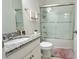 Bright bathroom features a granite countertop vanity, shower over tub, and decorative accents at 486 Disa Dr, Davenport, FL 33837