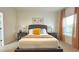 Comfortable bedroom featuring a large bed, neutral tones, and natural light from the window at 486 Disa Dr, Davenport, FL 33837