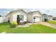 Charming single-Gathering home with manicured lawn, colorful landscaping, and brick paved driveway at 486 Disa Dr, Davenport, FL 33837